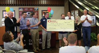 A group of CoreFirst employees presenting a check to the Friends of the Topeka Zoo