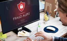 Woman looking at a fraud alert on her computer