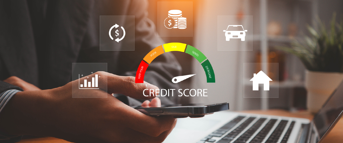 Man on his phone and computer with a gauge indicating a good credit score.