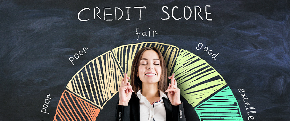 Woman crossing her fingers standing in front off a credit score graph