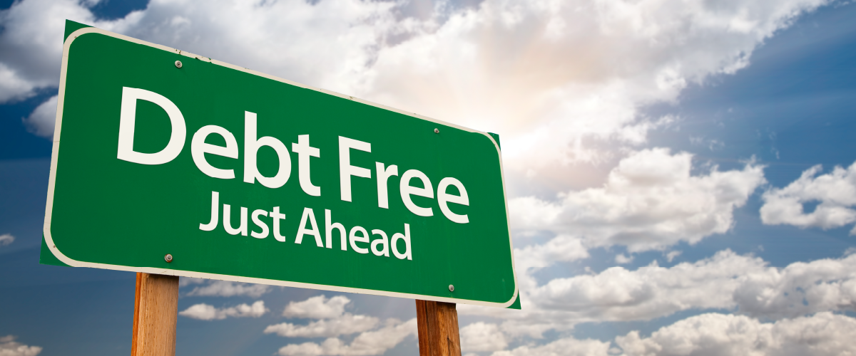 Road sign reading Debt Free Just Ahead.