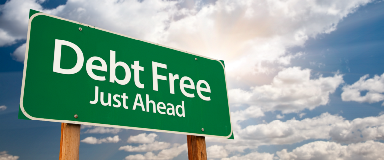 Road sign reading Debt Free Just Ahead.