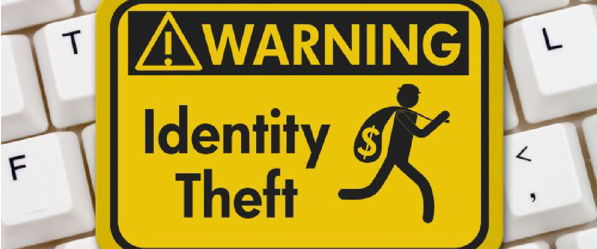 Warning sign for Identity Theft sitting on a keyboard