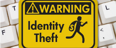 Warning sign for Identity Theft sitting on a keyboard