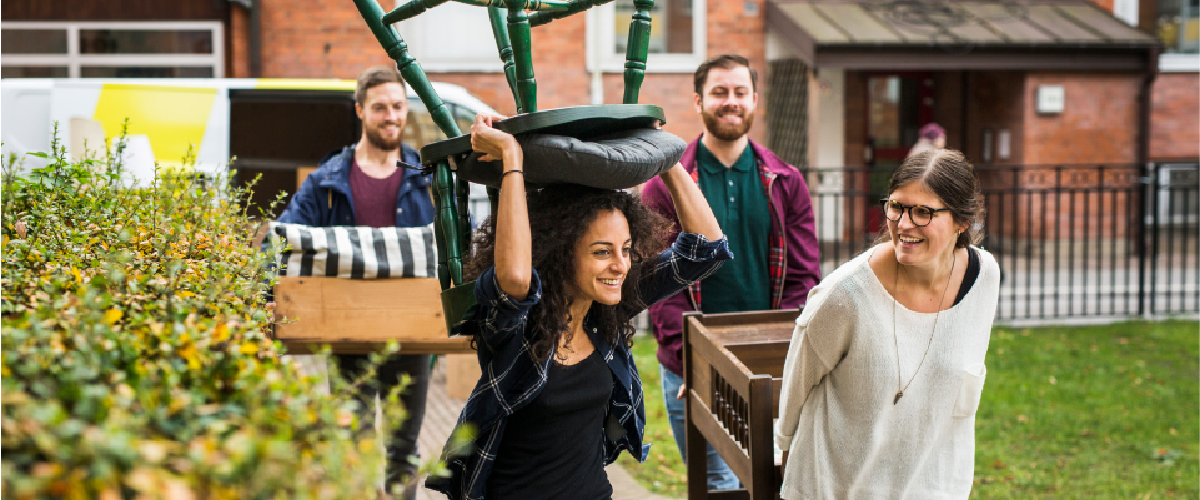 A group of friends carrying furniture together