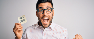 Excited man with a note reminding him to pay his taxes