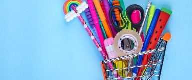A variety of school supplies in a shopping cart