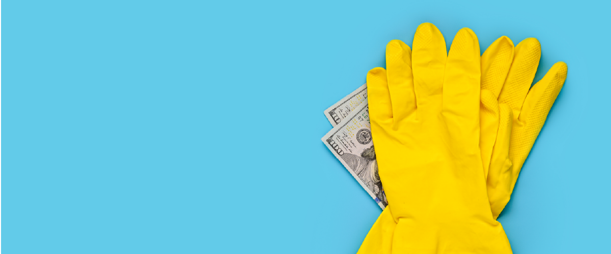 Two yellow cleaning gloves touching money.