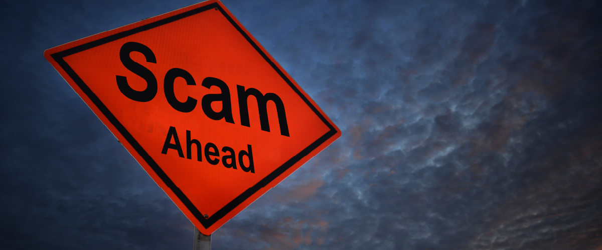 Sign that reads "Scam Ahead" with storm clouds in the background