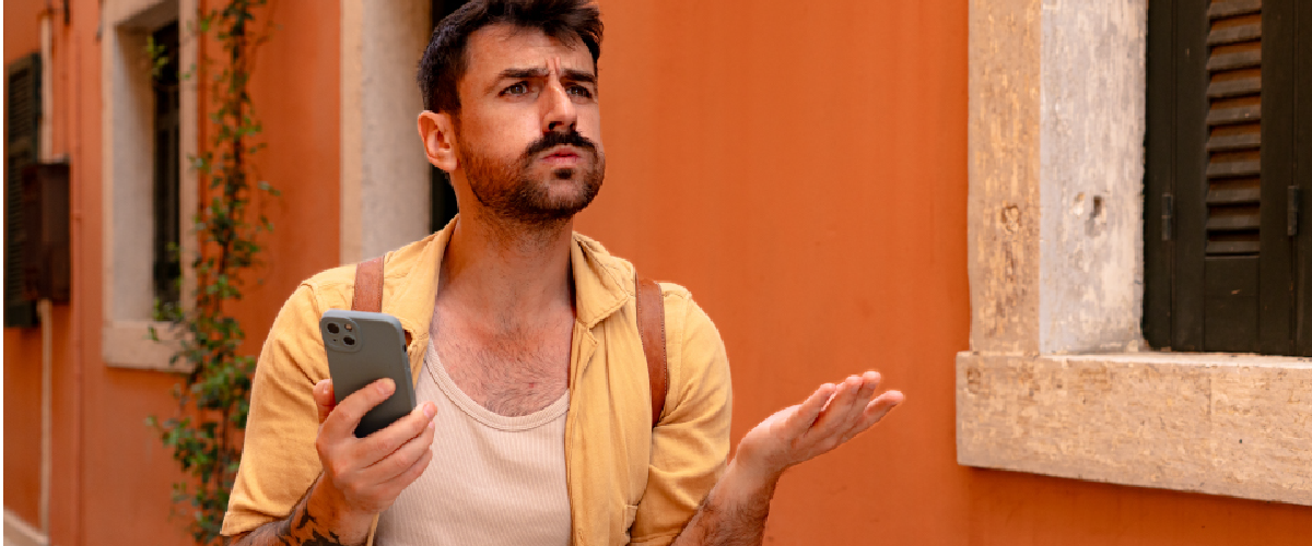 Confused and frustrated looking young man on vacation