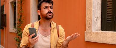 Confused and frustrated looking young man on vacation