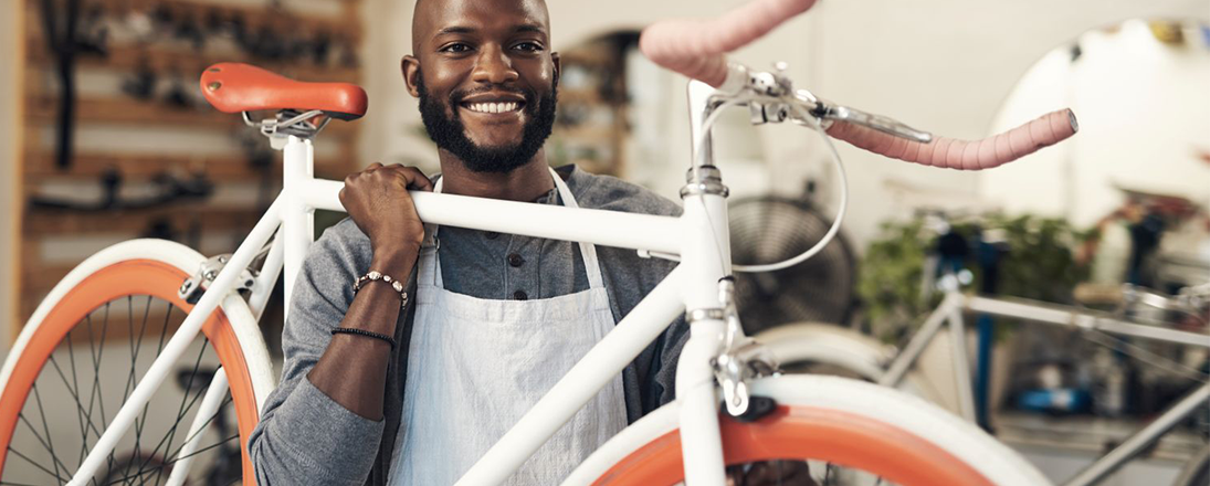 Bike shop owner holding a bike