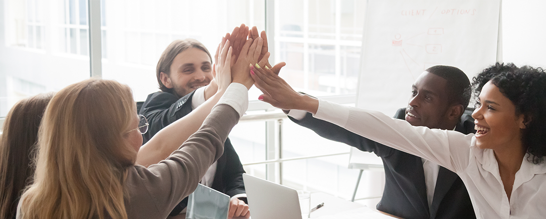 Group of business people high-fiving