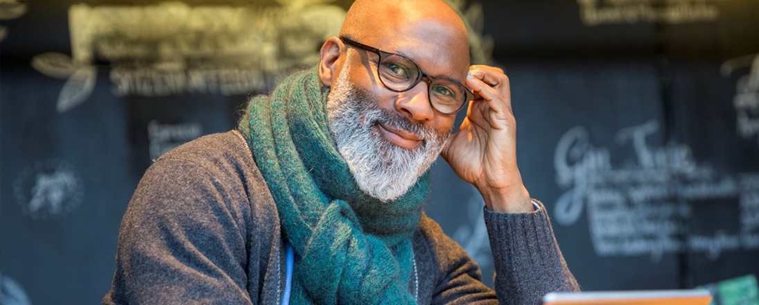 Business owner with beard and scarf.