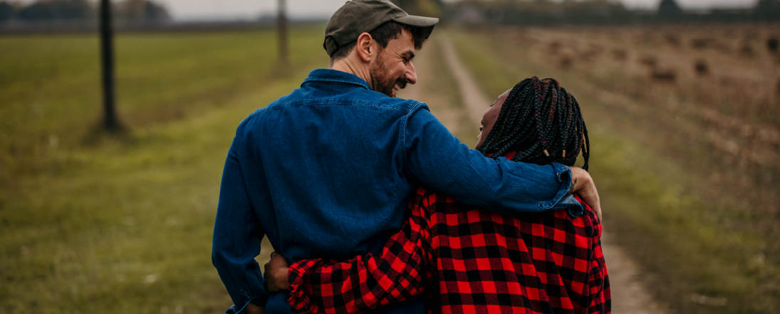 Two farmers walking arm in arm
