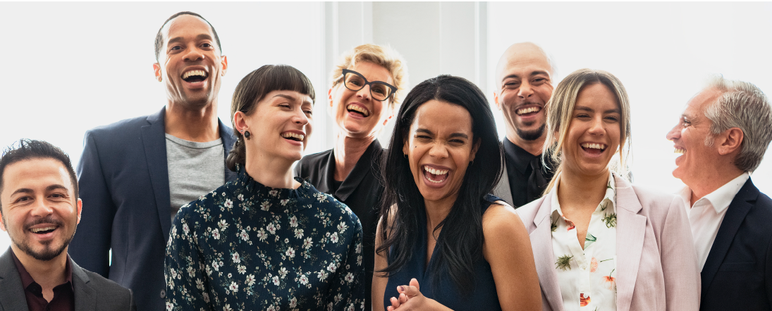 A group of diverse, happy coworkers smiling and laughing