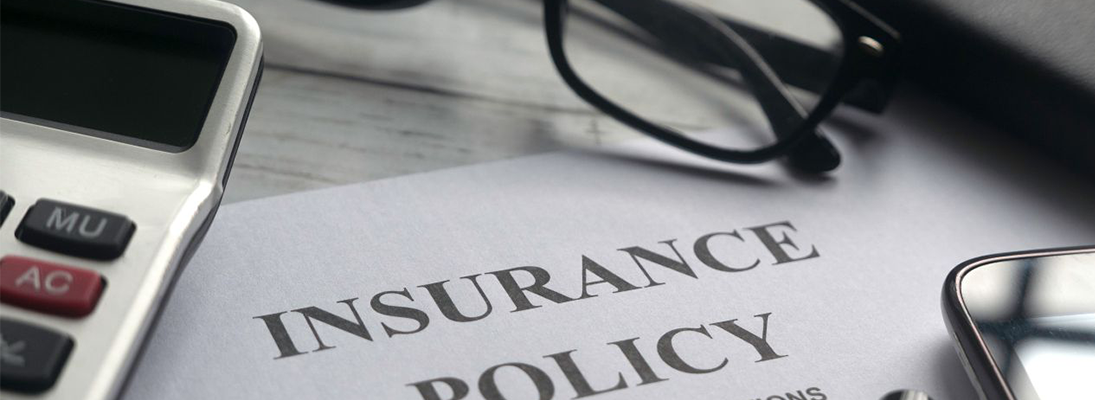 Insurance policy with a pair of reading glasses