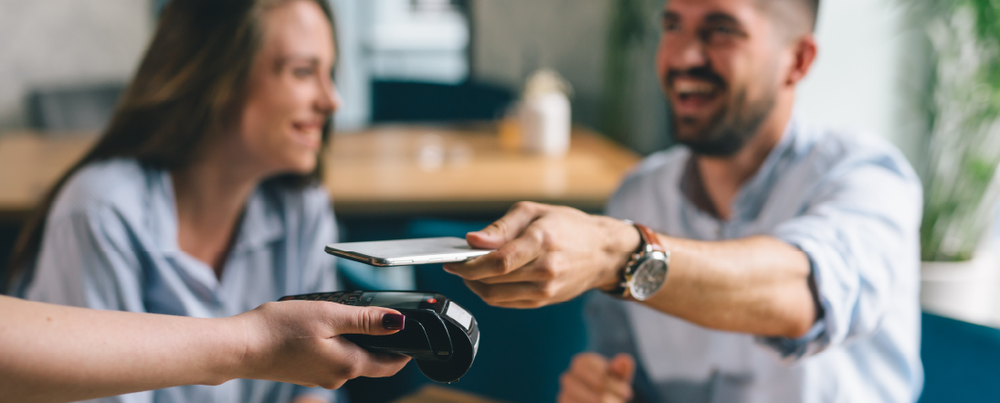 Man paying at a restaurant with his phone digital wallet