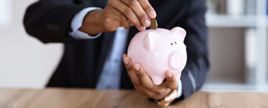 Man putting coins in piggy bank