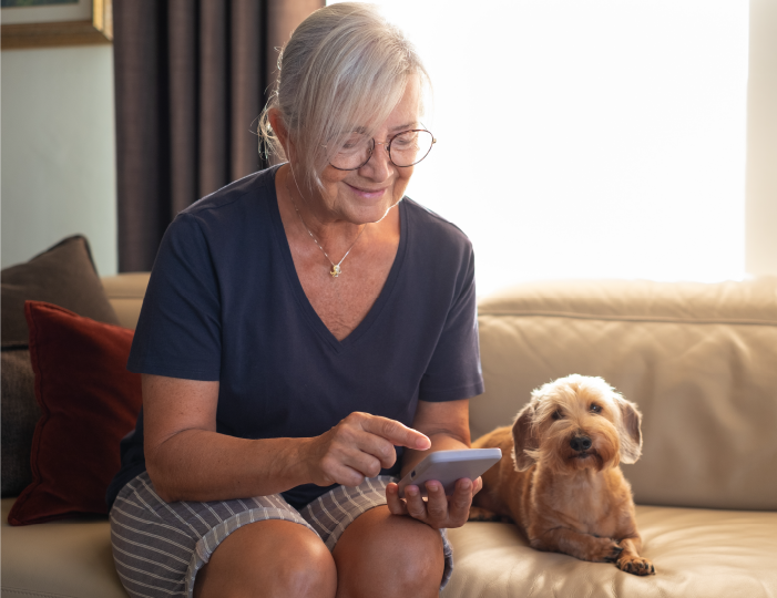 Woman looking at phone with her dog